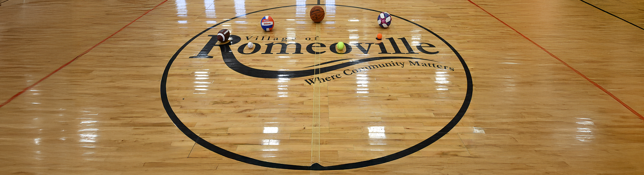Sports balls on gym floor of Athletic & Event Center